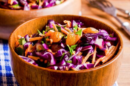 Healthy Vegan Coleslaw Salad Recipe - naturally dairy-free, gluten-free, nut-free, and loaded with nutritious ingredients. Includes cabbage, bell peppers, carrots, raisins, and optional hemp seeds.