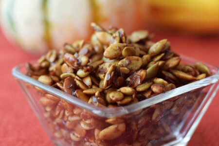 Spiced Maple Pumpkin Seeds - a simple, flavorful paleo and dairy-free recipe for using up leftover pumpkin seeds! Eat them straight, top a salad, or mix with dairy-free yogurt.