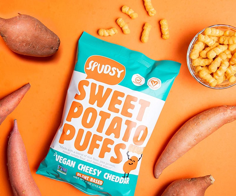 The Best Crunchy Cheesy Dairy-Free Snacks - from crackers to chips, puffs to popcorn, and more! Vegan, Gluten-Free, and Grain-Free Options. Pictured: Spudsy Sweet Potato Puffs in Vegan Cheddar