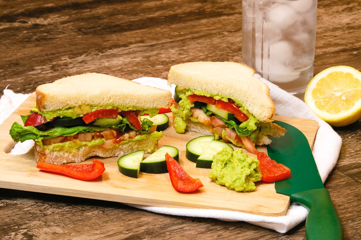 The Ultimate Plant-Based Sandwich Recipe with Smashed Avocado. Dairy-free, vegan, and includes a fresh array of whole grain bread and topping options.